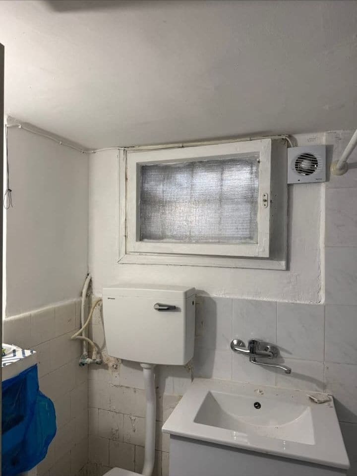 The same bathroom with smooth, freshly painted white walls