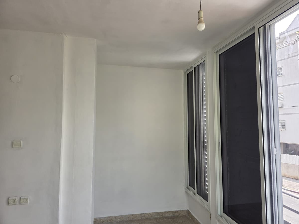 The same corner, column rebuilt and painted white