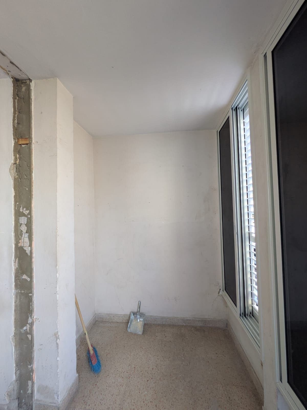 Corner column stripped back to bare concrete