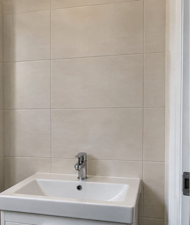 Before: tiled wall above a bathroom basin