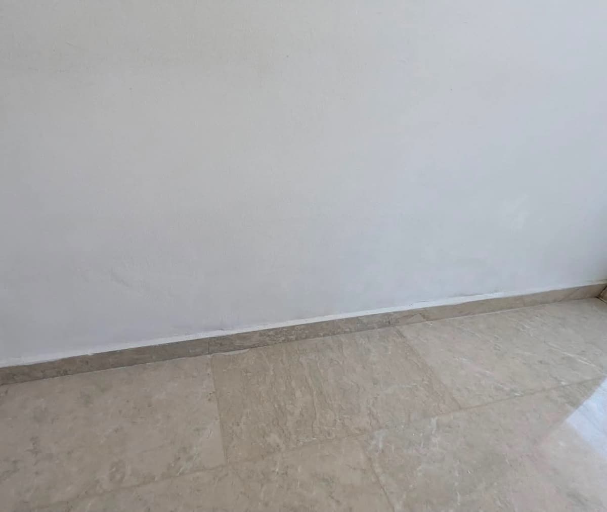 The repaired wall, smooth and repainted